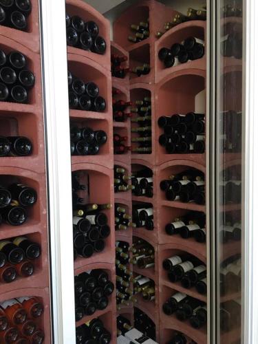 a room filled with lots of bottles of wine at Residence Hôteliere Hurlevent in Grande Anse