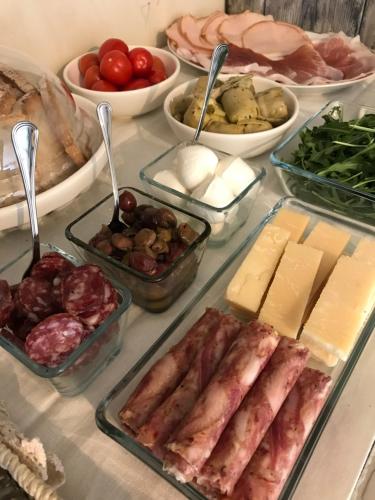 a table topped with trays of different types of food at Charme in Perillis in Popoli