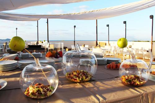 a table with three clear containers filled with food at Resort Il Mulino in Favignana