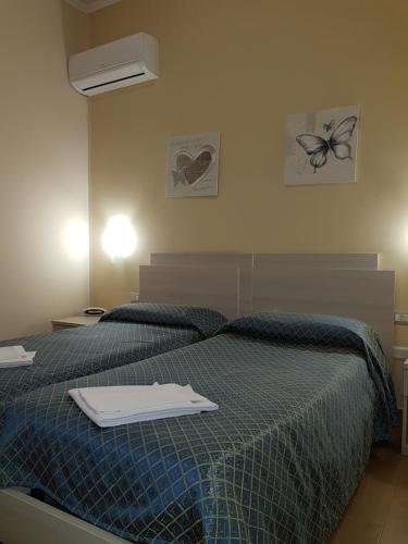 Postel nebo postele na pokoji v ubytování Hotel Il Quadrifoglio