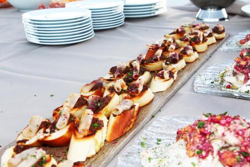 a table topped with appetizers and plates of food at Resort Il Mulino in Favignana
