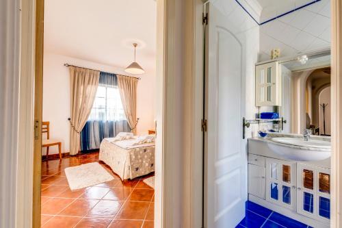 a bathroom with a sink and a bed in a room at Altura Prime - 5 Suites, Private Pool and Parking, Walk to Beach in Altura