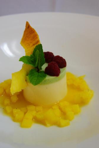 a piece of cake with fruit on a white plate at Hotel Seefischer - Finest Hideaway in Döbriach