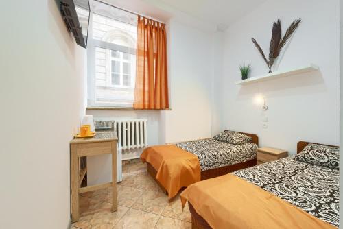 a room with two beds and a window at hostelswidnicka24 in Wrocław