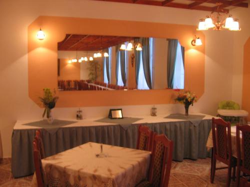 a meeting room with two tables and a mirror at Mater Salvatoris House in Gödöllő