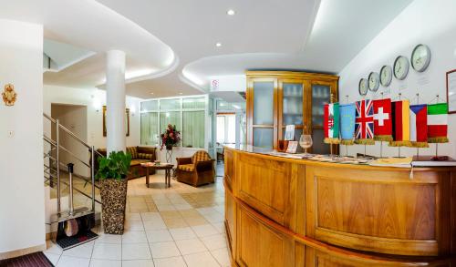 a lobby with a counter with flags on it at Kata Panzió in Szeged