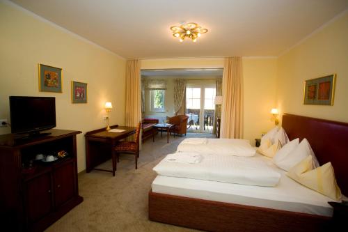 a hotel room with a bed and a television at Hotel Seefischer - Finest Hideaway in Döbriach