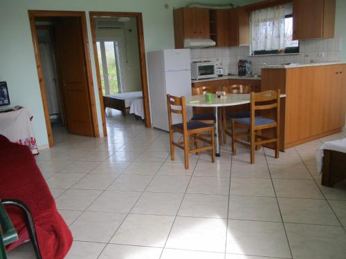 a kitchen with a table and chairs in a room at Ammodares in Lixouri