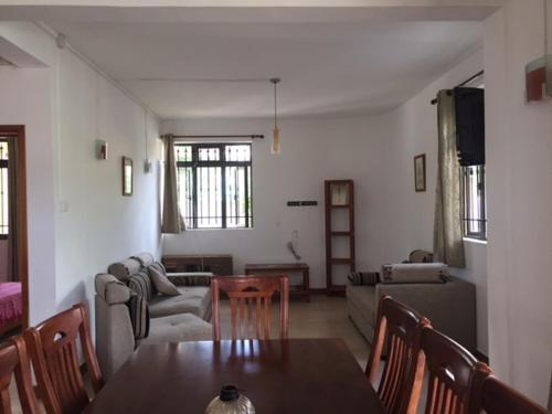 a living room with a table and a couch at Villa Tameva in Flic-en-Flac