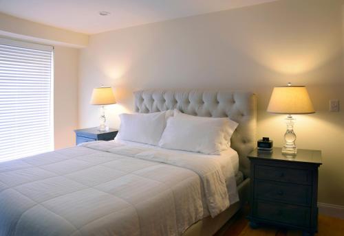 a bedroom with a bed and a lamp at Bricco Suites in Boston