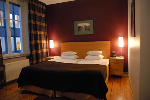 a bedroom with a bed with two pillows at Rex Hotel in Stockholm
