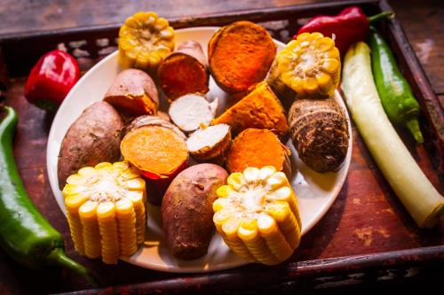 a plate of food with vegetables on a table at Rural House in Yangshuo