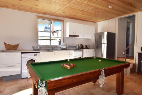 a kitchen with a pool table in a room at Absolute Waterfront in Brisbane