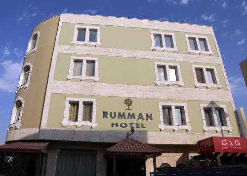 
a building with a sign on the front of it at Rumman Hotel in Madaba
