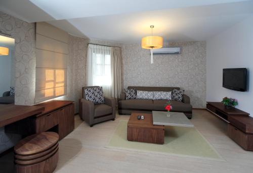 a living room with a couch and a table at Torbahan Hotel in Torba