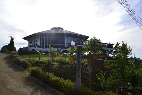 a house with a car parked in front of it at Mesilau Mountain Retreats in Kundasang