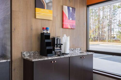 a coffee machine sitting on a counter in a room at Motel 6-Savannah, GA - Midtown in Savannah