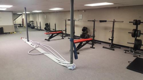 a gym with several rows of exercise equipment in a room at Super 8 by Wyndham Osceola IA in Osceola