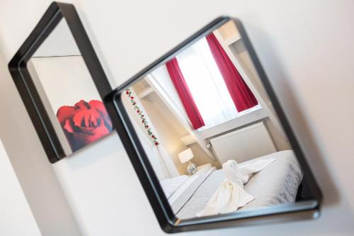 a mirror reflection of a bed in a room at Hotel Zilt in Vlissingen