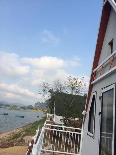 a balcony of a house with a view of the water at Carambola Bungalow in Phong Nha