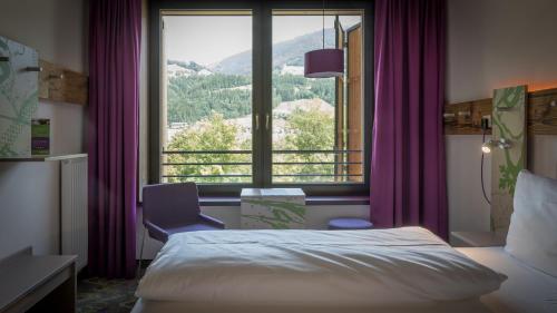 Ένα ή περισσότερα κρεβάτια σε δωμάτιο στο Explorer Hotel Zillertal