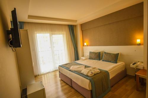 Postel nebo postele na pokoji v ubytování ParionHouse Hotel
