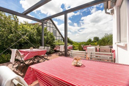 a patio with a table and two tables and chairs at H.W.S. Hotel Der Wilde Schwan in Sagard