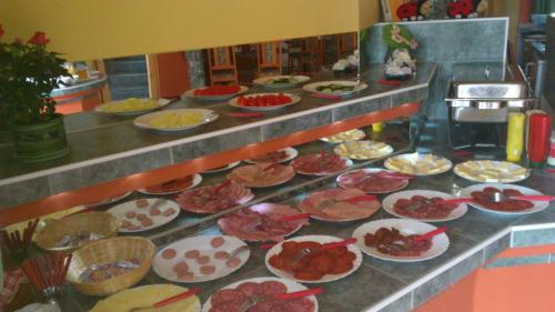 a buffet line with many plates of food at Erika Pension in Keszthely