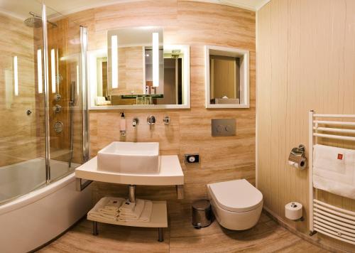 a bathroom with a sink and a shower and a toilet at Mama's Design & Boutique Hotel in Bratislava