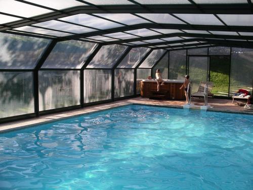 a swimming pool inside of a glass house at La Torre Blanca in Cardona