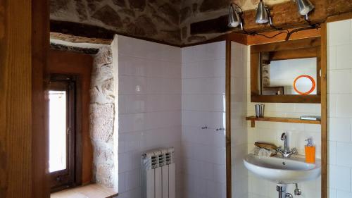 a bathroom with a sink and a mirror at La Torre Blanca in Cardona