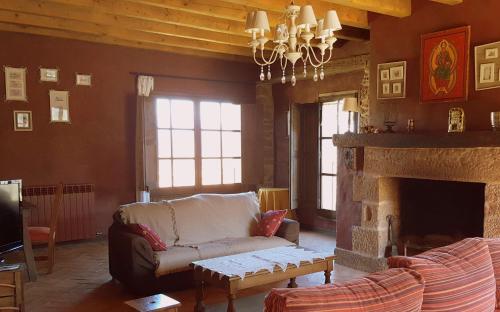 a living room with a couch and a fireplace at La Torre Blanca in Cardona