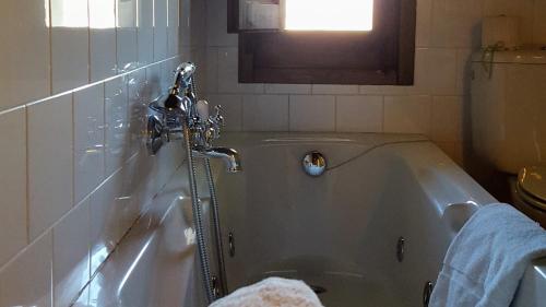 a bath tub with a faucet in a bathroom at La Torre Blanca in Cardona