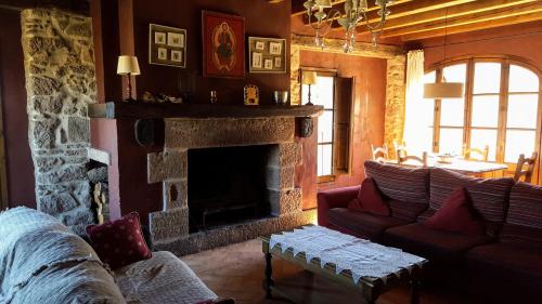a living room with a couch and a fireplace at La Torre Blanca in Cardona