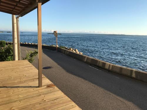 a view of the ocean from a dock with a sign at Notojima Guesthouse HaNaMi in Nanao