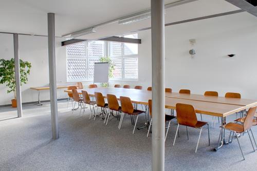 a conference room with a long table and chairs at Gasthof Mühle in Aesch