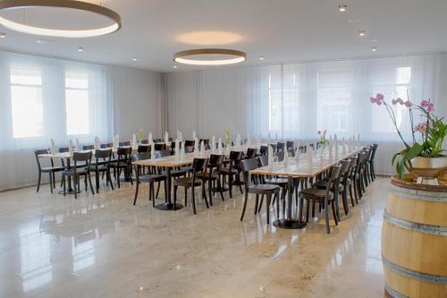 a large room with tables and chairs and windows at Gasthof Mühle in Aesch