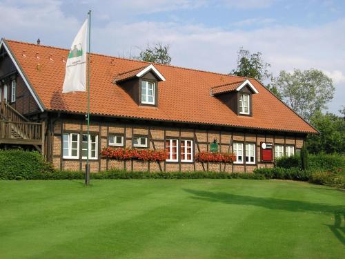 a house with a flag in front of it at Best Western Premier Seehotel Krautkrämer in Münster