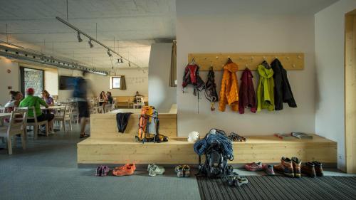 a room with a bunch of clothes hanging on a wall at Galyatető Turistacentrum in Galyatető