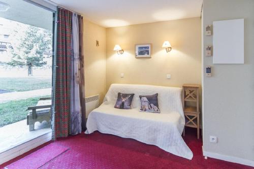 a bedroom with a bed with two pillows on it at Residence Le Sequoia - maeva Home in Bolquere Pyrenees 2000