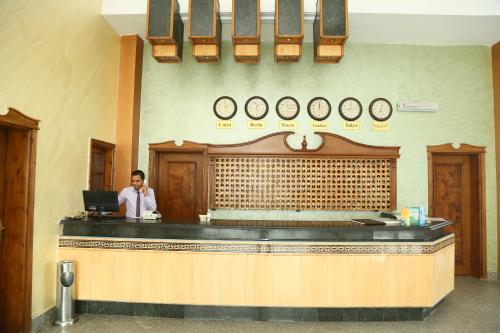 a man standing at a counter in a restaurant at Happy Life Village Dahab in Dahab