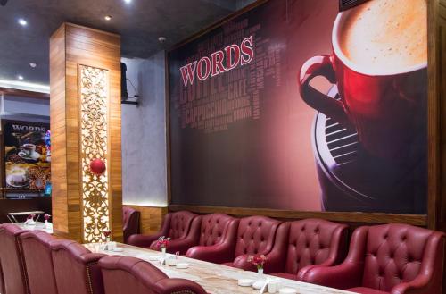 a restaurant with a long table with a large coffee mug on the wall at Golden Inn Hotel in Cairo