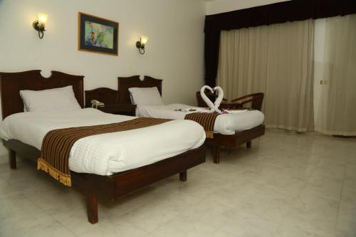 a hotel room with two beds with bows on them at Happy Life Village Dahab in Dahab