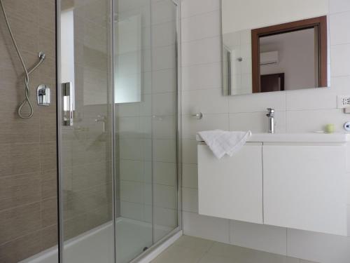 a bathroom with a shower and a sink and a mirror at La casa del Moro in Sabaudia
