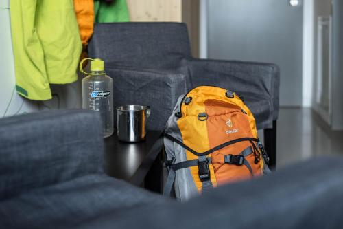 a backpack sitting on a table next to two chairs at Galyatető Turistacentrum in Galyatető