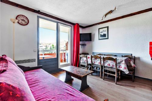 a bedroom with a bed and a table with chairs at Residence Les Bergers - maeva Home in L'Alpe-d'Huez