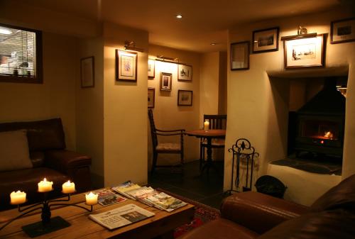a living room with a couch and a fireplace at The Turtley Corn Mill in South Brent