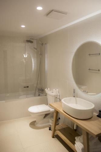 a bathroom with a sink and a toilet and a mirror at XII Century Heritage Hotel in Trogir
