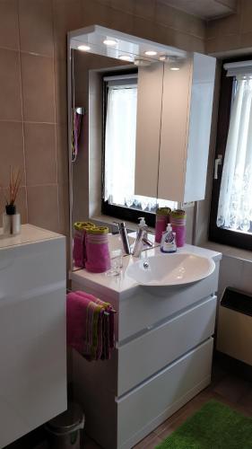 a bathroom with a white sink and a mirror at Haus Senn in Seefeld in Tirol