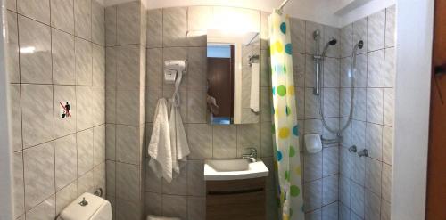 Un baño con lavabo, inodoro y ducha. en Hotel Anthousa, en Samos